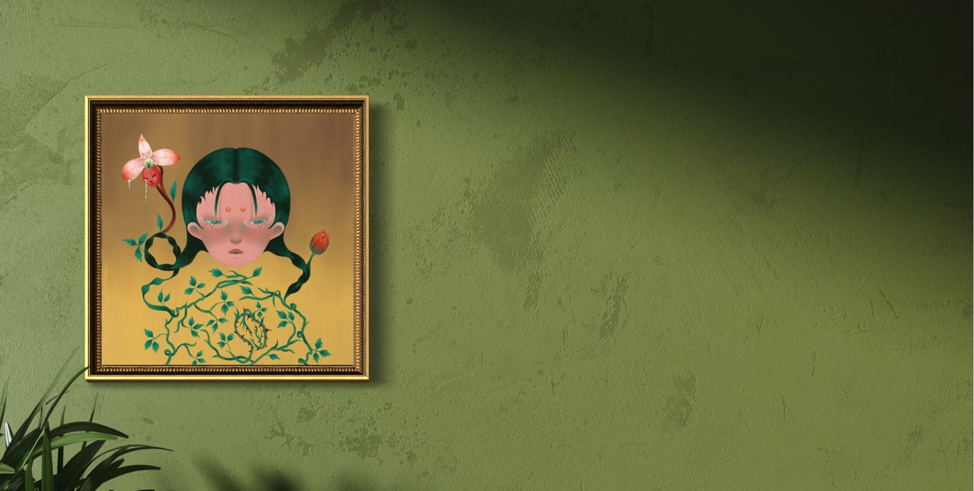 Framed artwork of a floral design on a textured green wall.